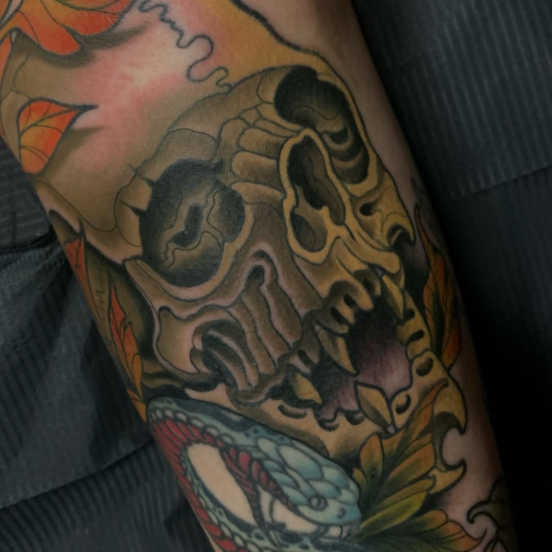 Bold skull centerpiece with heavy outlines and autumn leaves