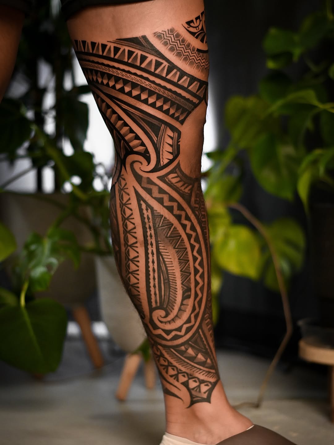 Intricate blackwork Polynesian leg sleeve with geometric motifs