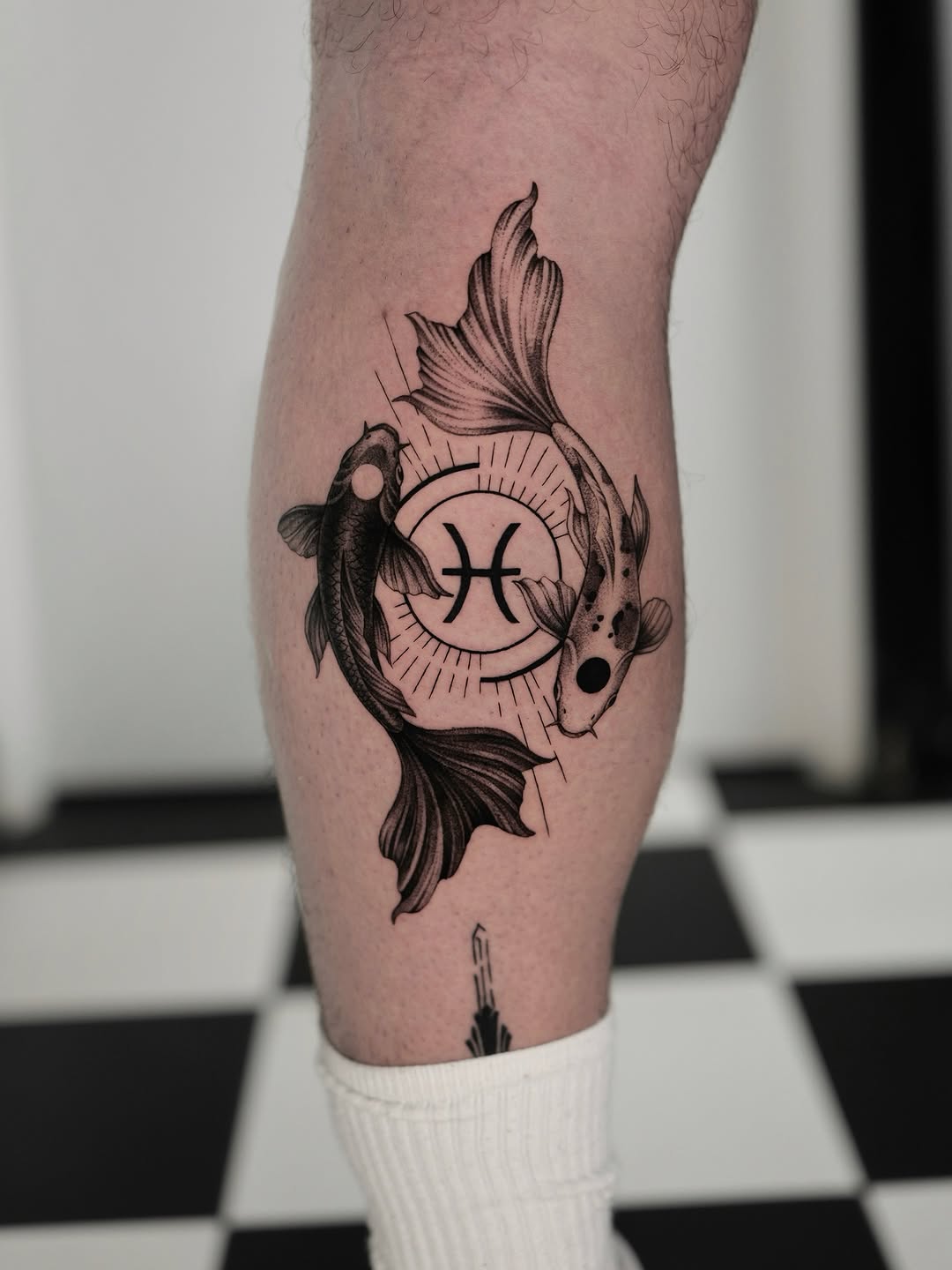 Symmetrical two koi fish circle around a radiant Pisces glyph