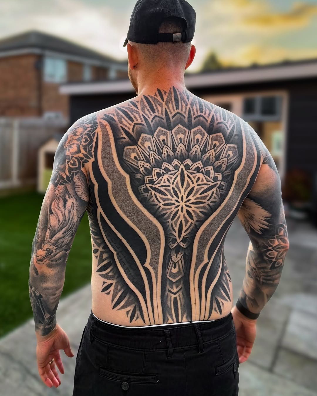 Intricate blackwork back piece with bold geometric mandala