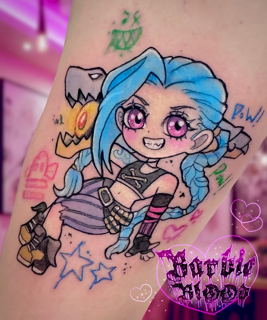 Chibi Jinx arcane-style tattoo with vibrant blue hair.