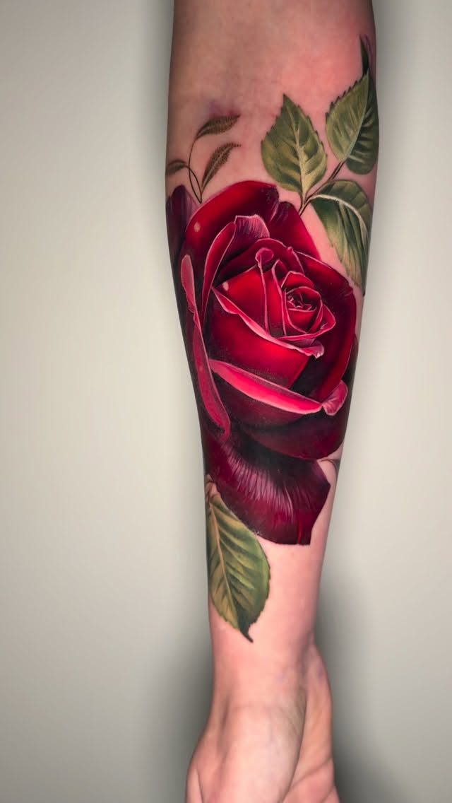 Vibrant hyper-realistic red rose with lush green leaves
