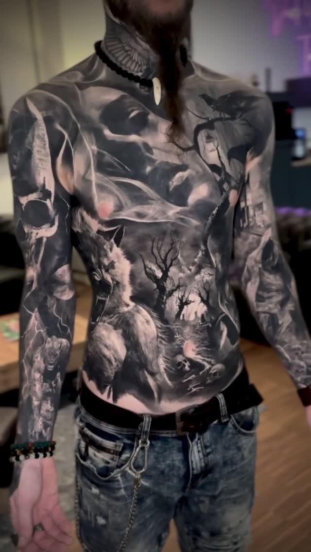 Mysterious black-and-gray fantasy forest scene across chest and arms