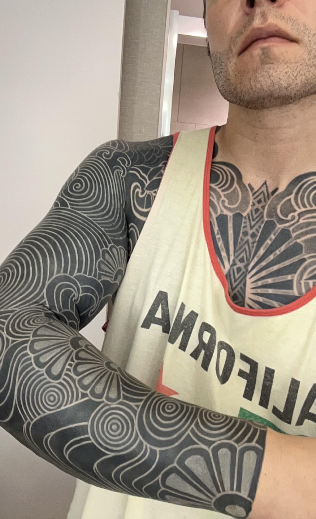 White-on-black freehand sleeve featuring swirling circular patterns