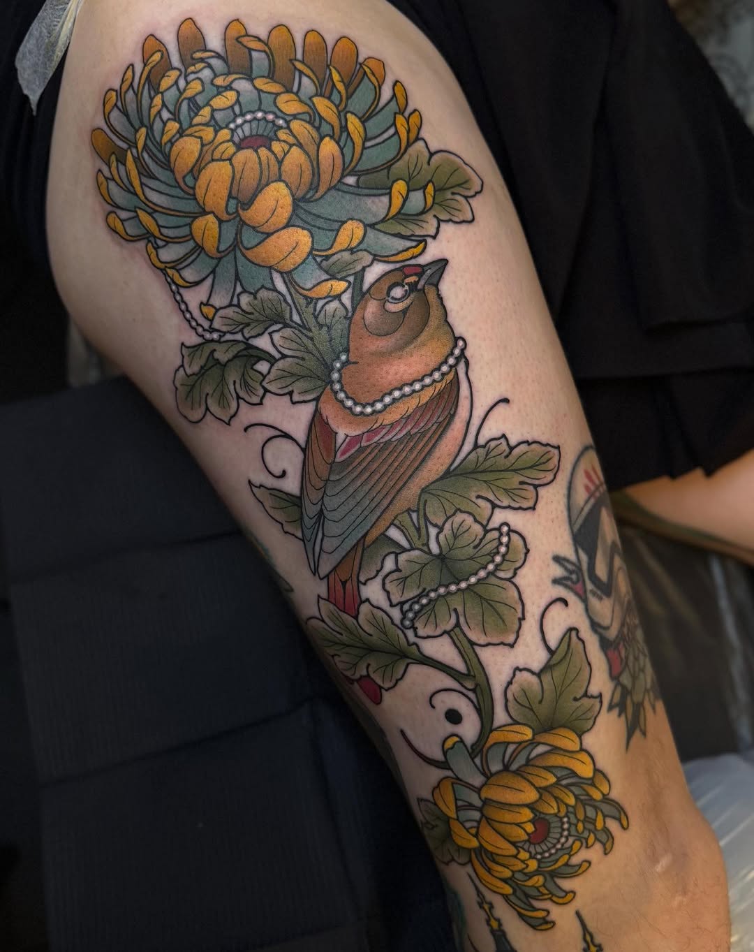 Vibrant neo-traditional robin with pearl necklace among chrysanthemums