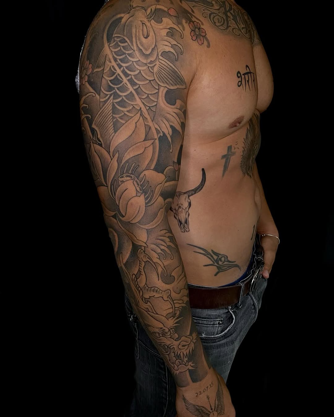 Japanese sleeve with koi, waves, florals, and skull accents