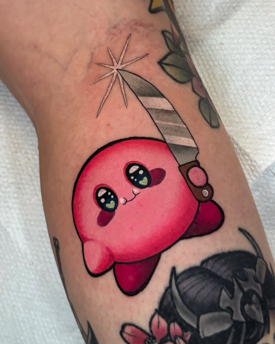 Adorable pink Kirby wielding a gleaming knife, bold lines