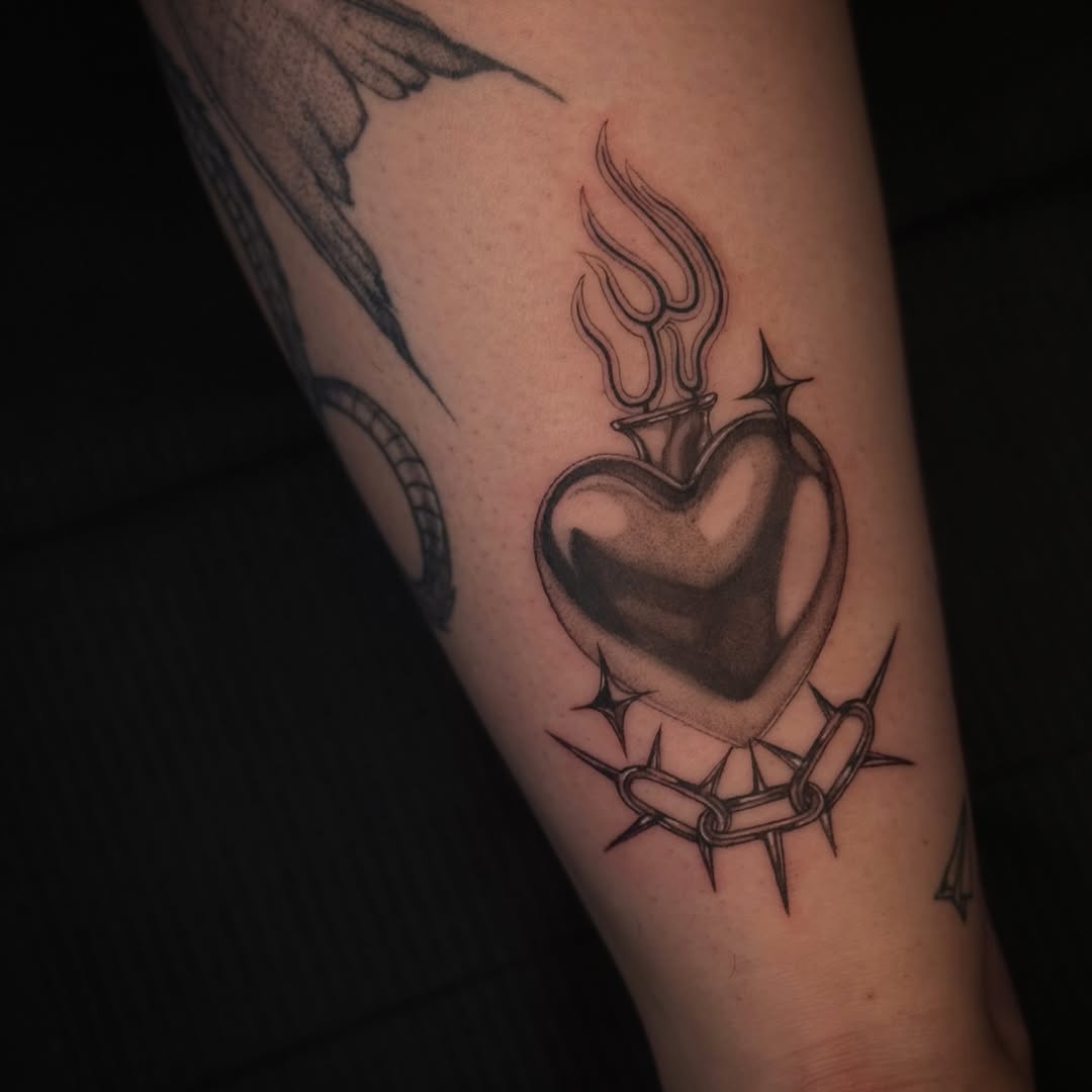 Bold black heart with flames, wrapped by barbed wire.