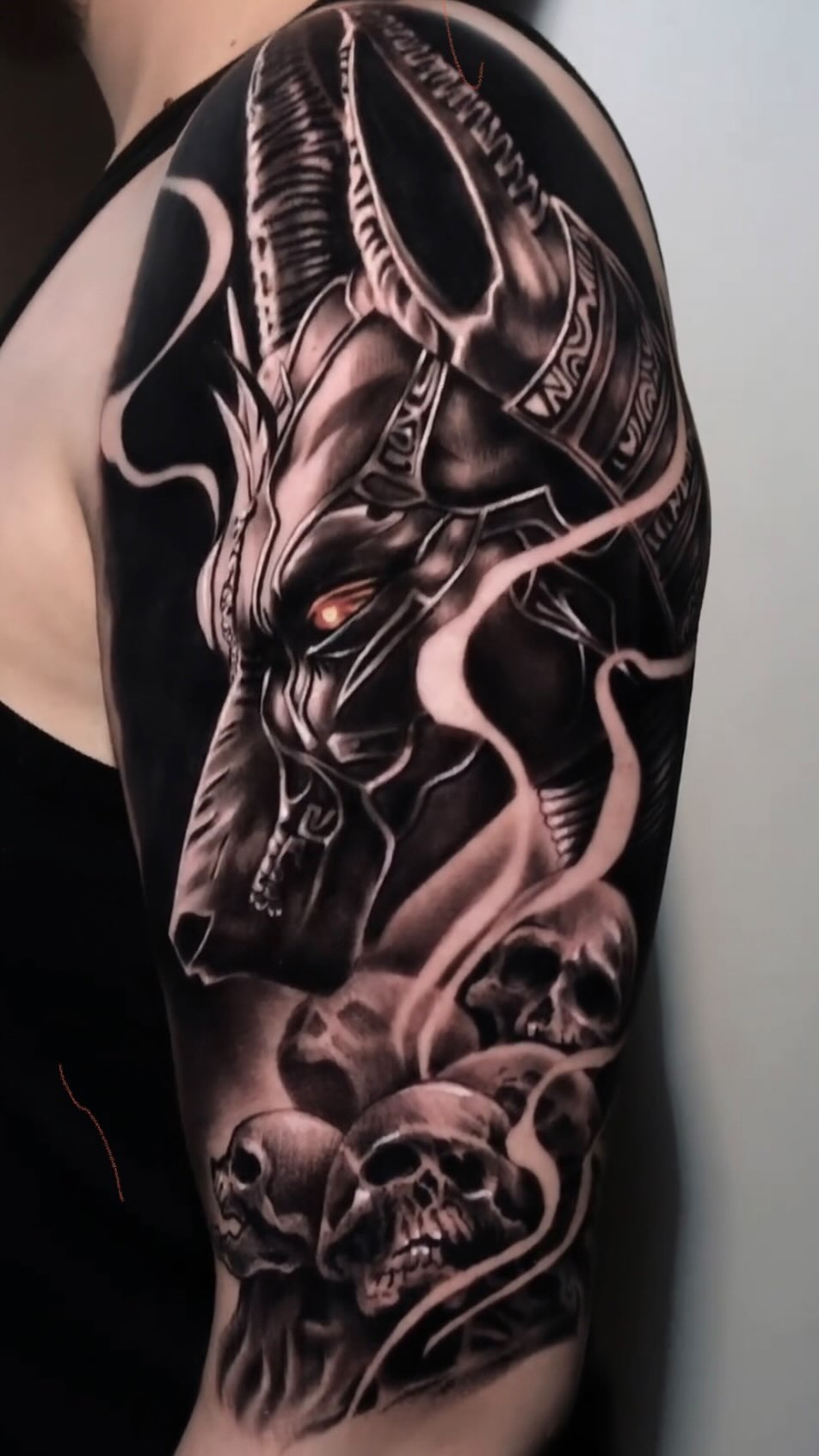 Dramatic black-and-gray demonic horse head with skulls