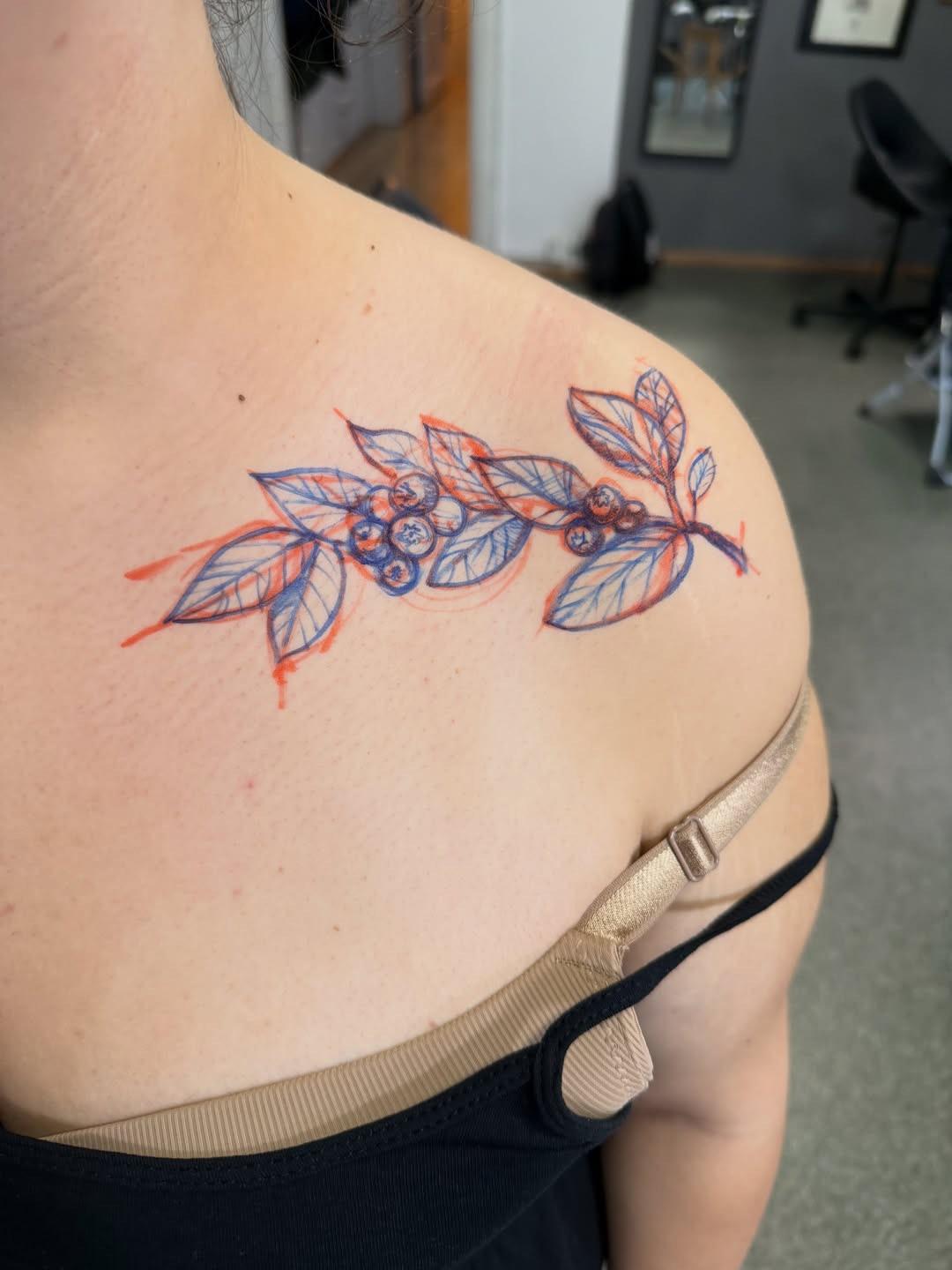 Delicate botanical branch in blue linework with red accents
