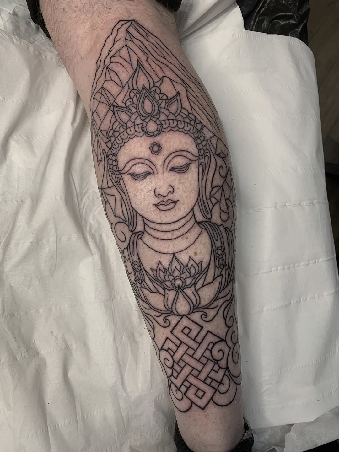 Calm Buddha head in bold linework with lotus accents