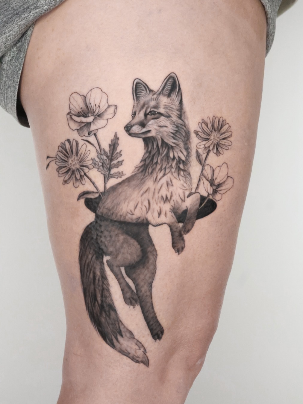 Elegant grayscale fox surrounded by blooming flowers; whimsical.