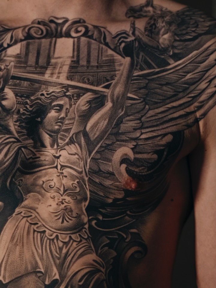 Monumental black-and-gray realism of a winged angelic warrior