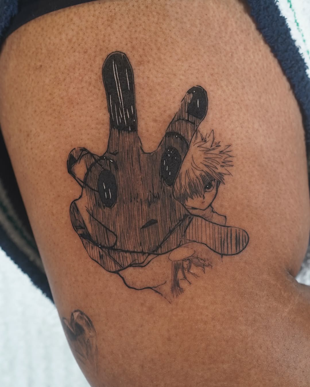 Bold blackwork hand with Gon silhouette, fine-line shading.