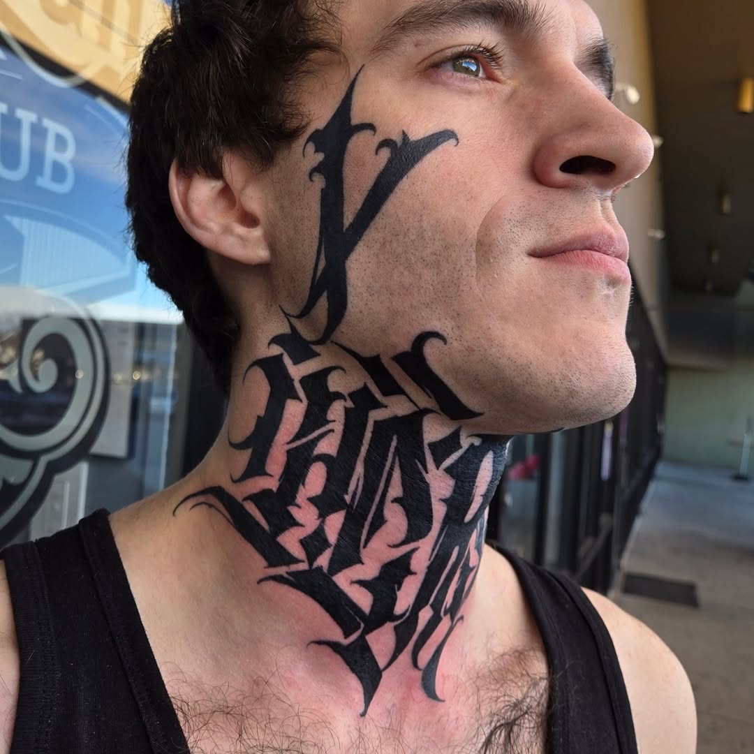 Bold blackwork neck piece with interlocking lettering