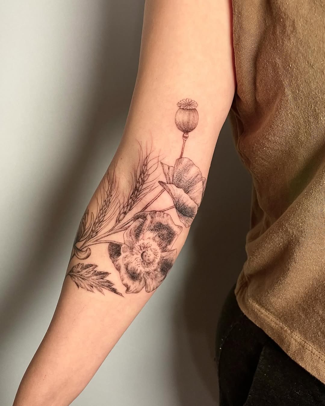 Delicate botanical forearm wrap with poppy and wheat