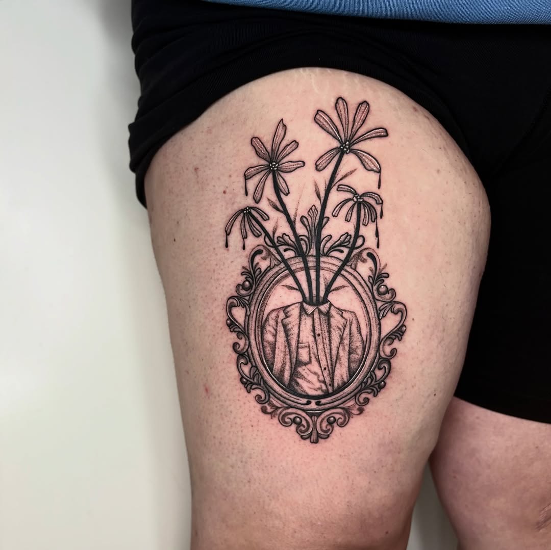 Surreal blackwork portrait: suit torso with blooming flowers.