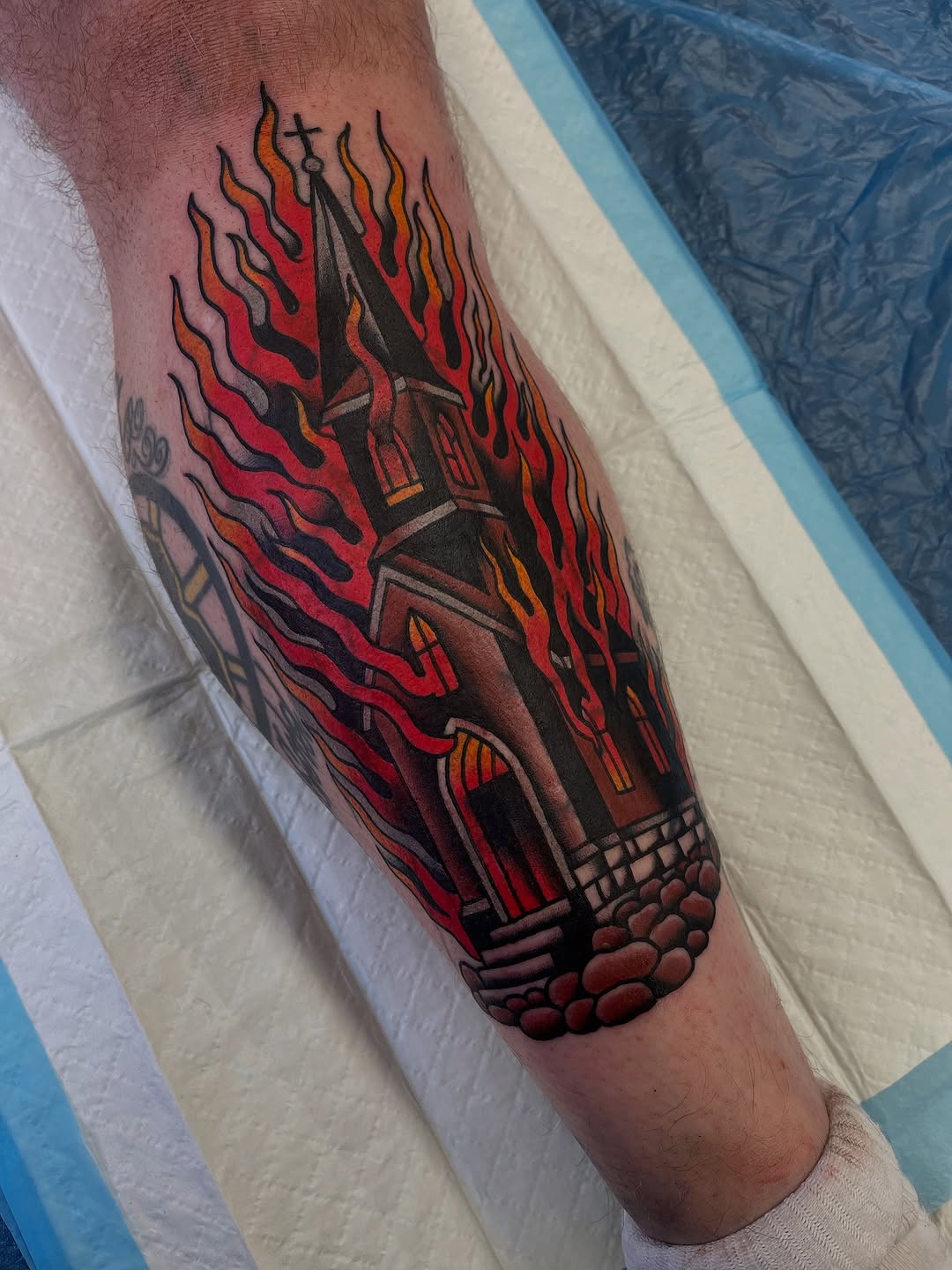 Fiery gothic church tower surrounded by bold flames