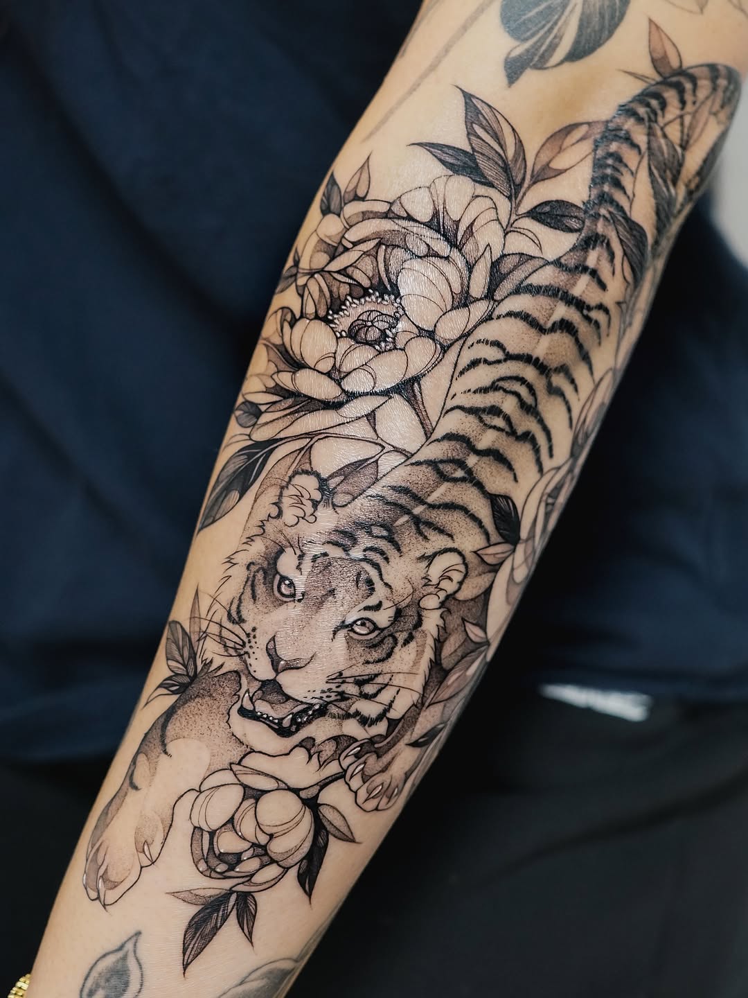 Intricate tiger and peony bloom in graceful fineline.