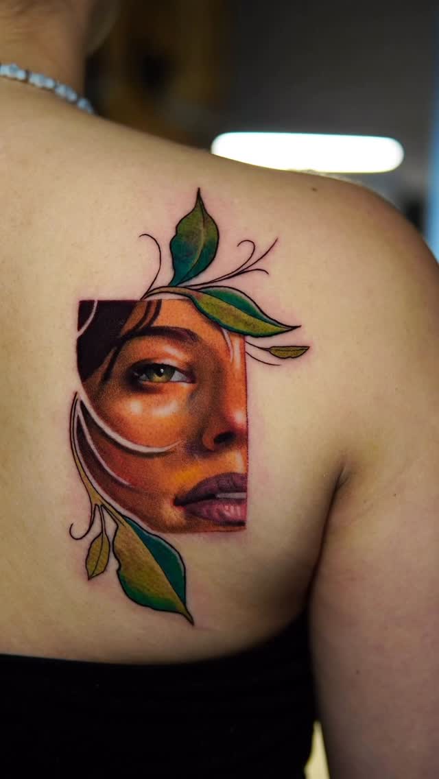 Vivid half-face portrait with leafy, curling botanical frame.