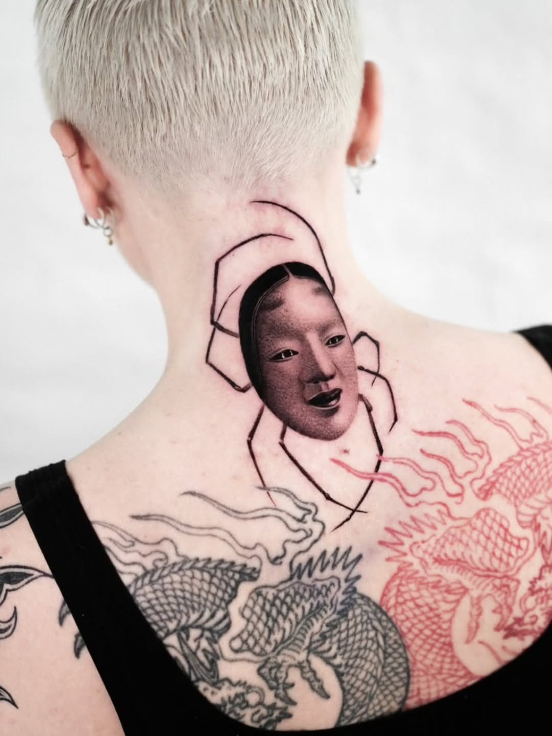 Geometric halo frames a grayscale portrait on the neck.