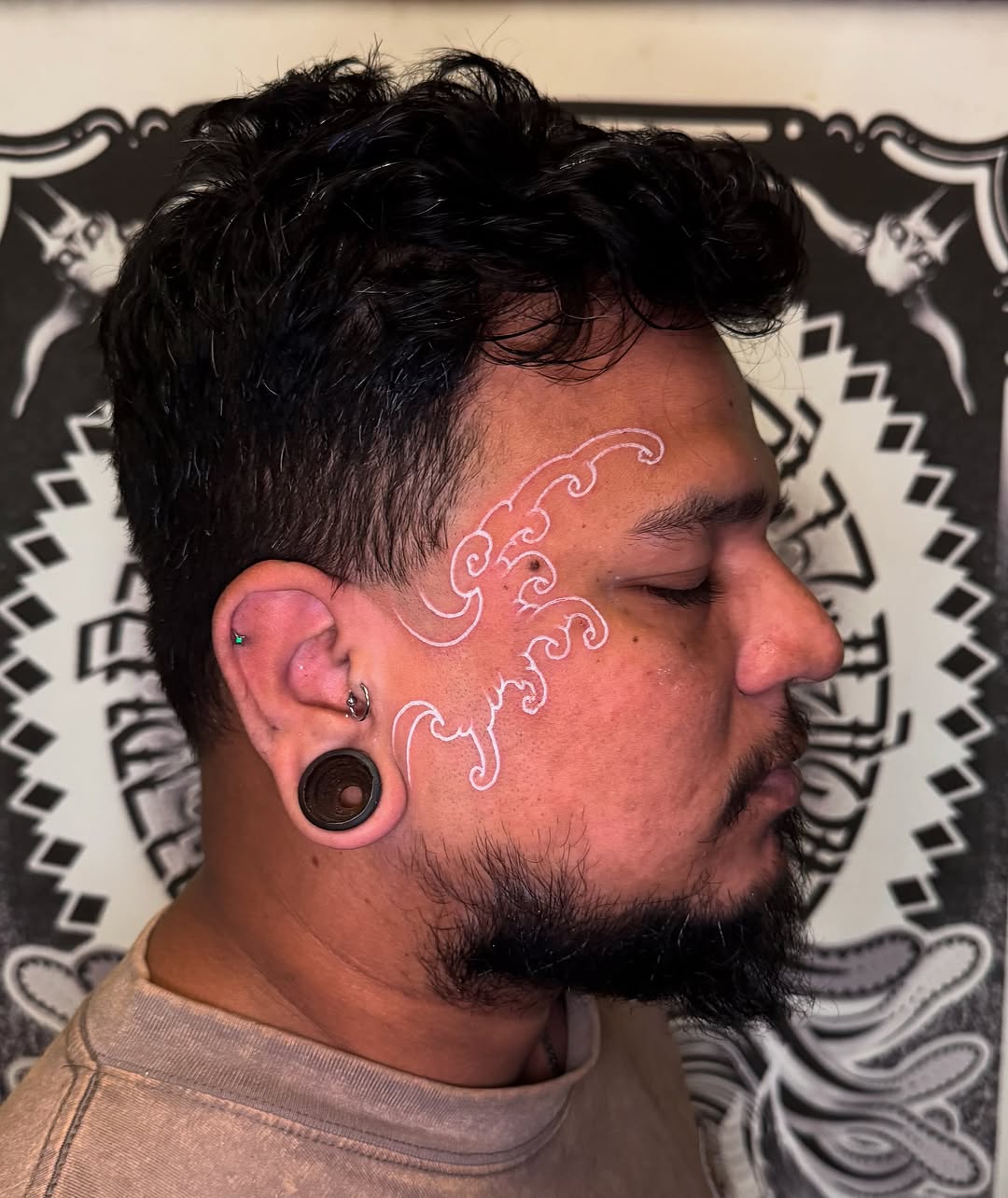 Delicate white-ink cloudwork spiraling along temple.