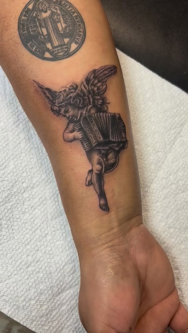 Winged angel with accordion, bold linework, ethereal shading.