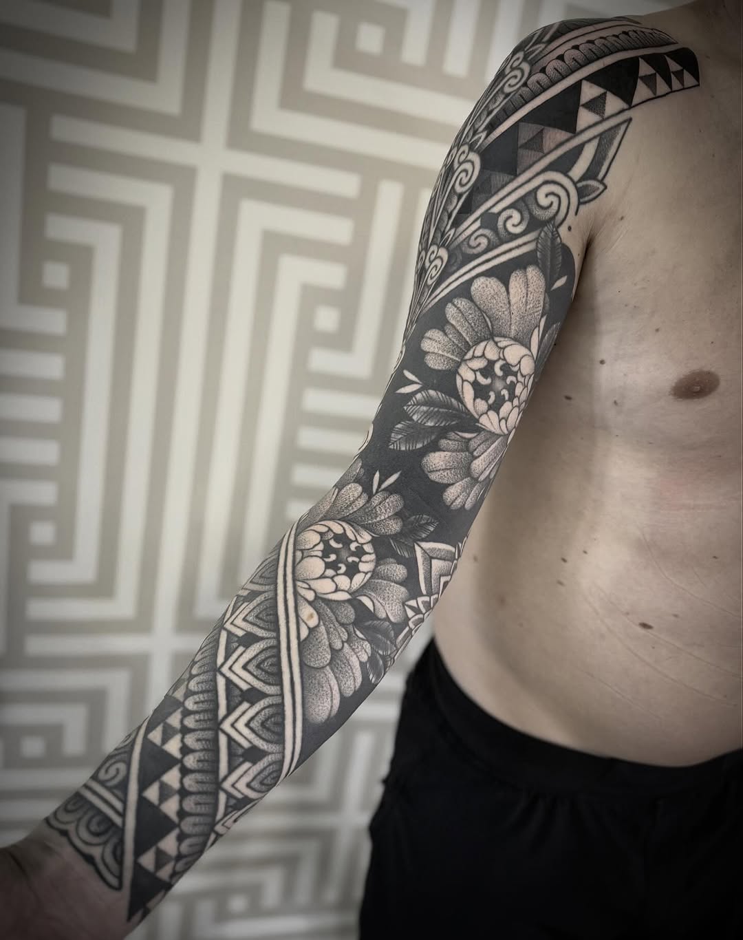 Intricate blackwork floral-geometric sleeve with bold patterns