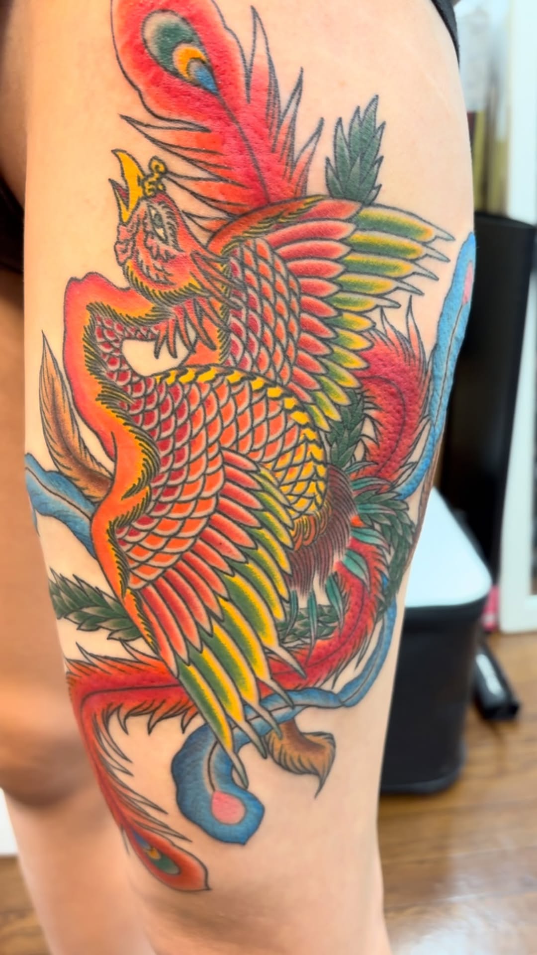 Vivid Japanese phoenix with bold linework, rainbow scales