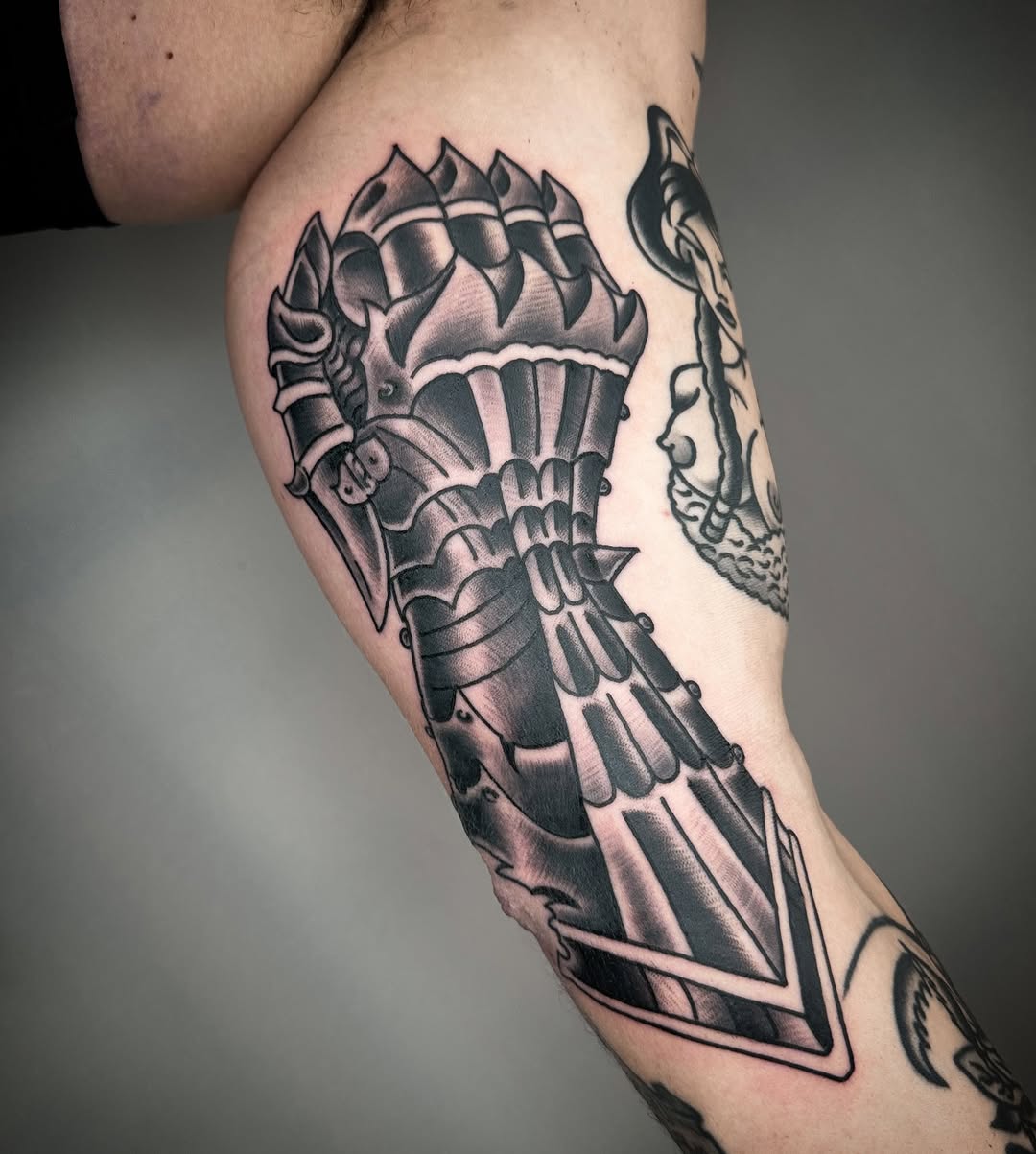 Bold blackwork gauntlet armor with layered plating.