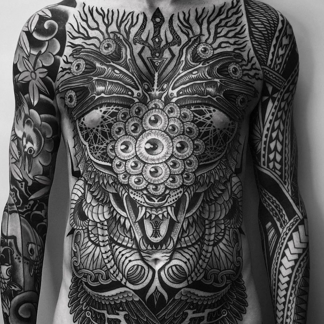 Intricate blackwork chest piece featuring a mandala-eyed demon