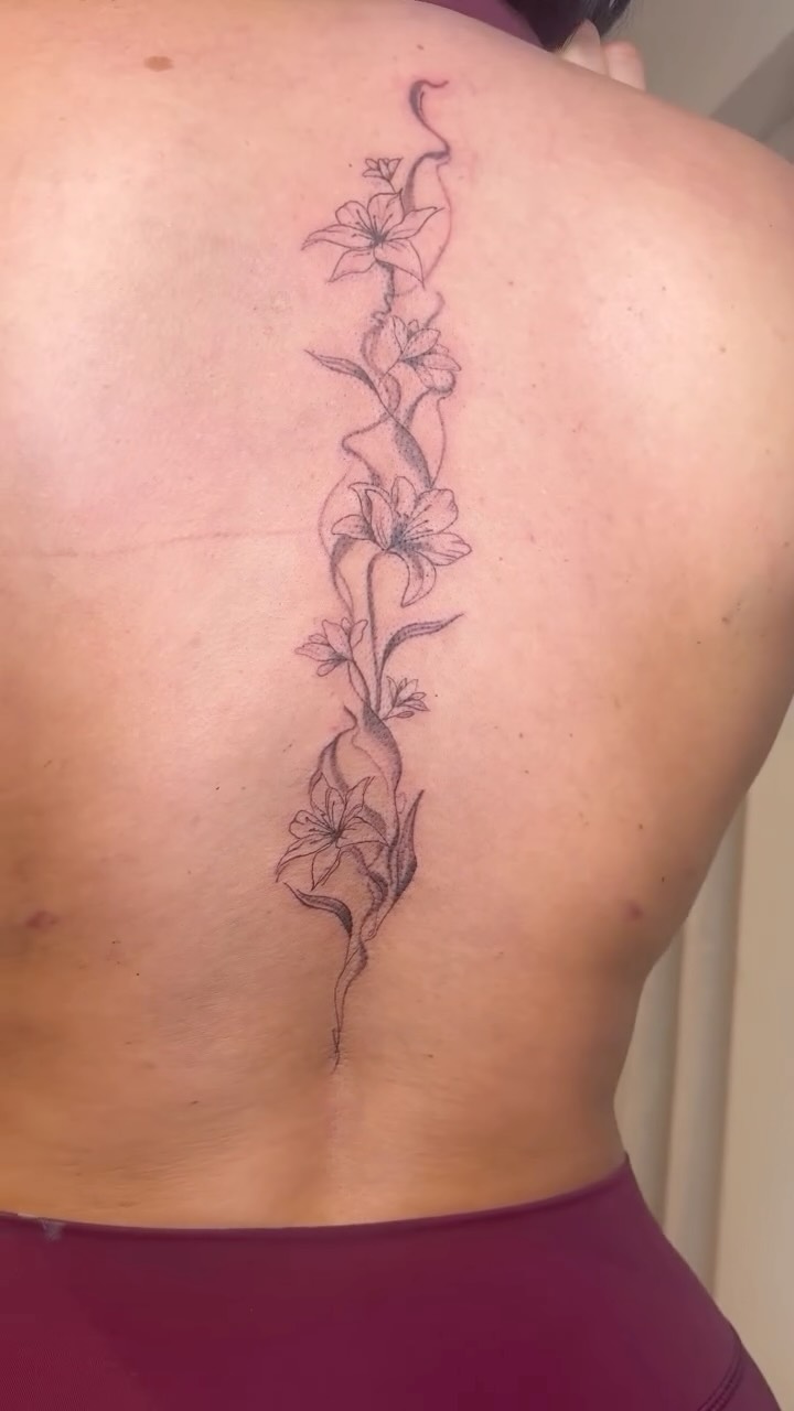 Delicate vertical floral vine along the spine in fine lines