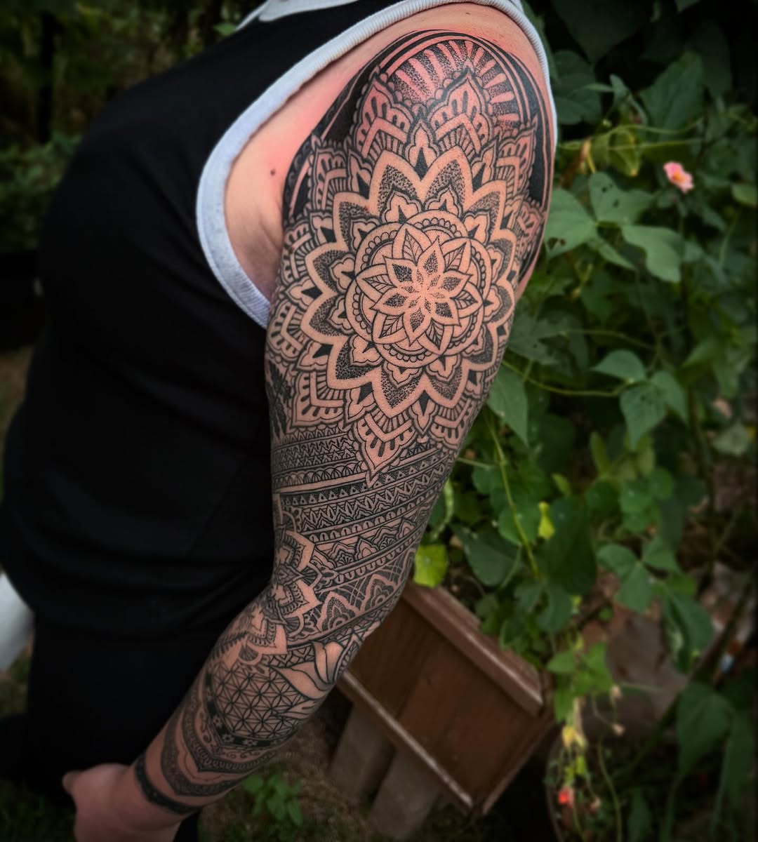 Intricate blackwork mandala sleeve with geometric dotwork shading