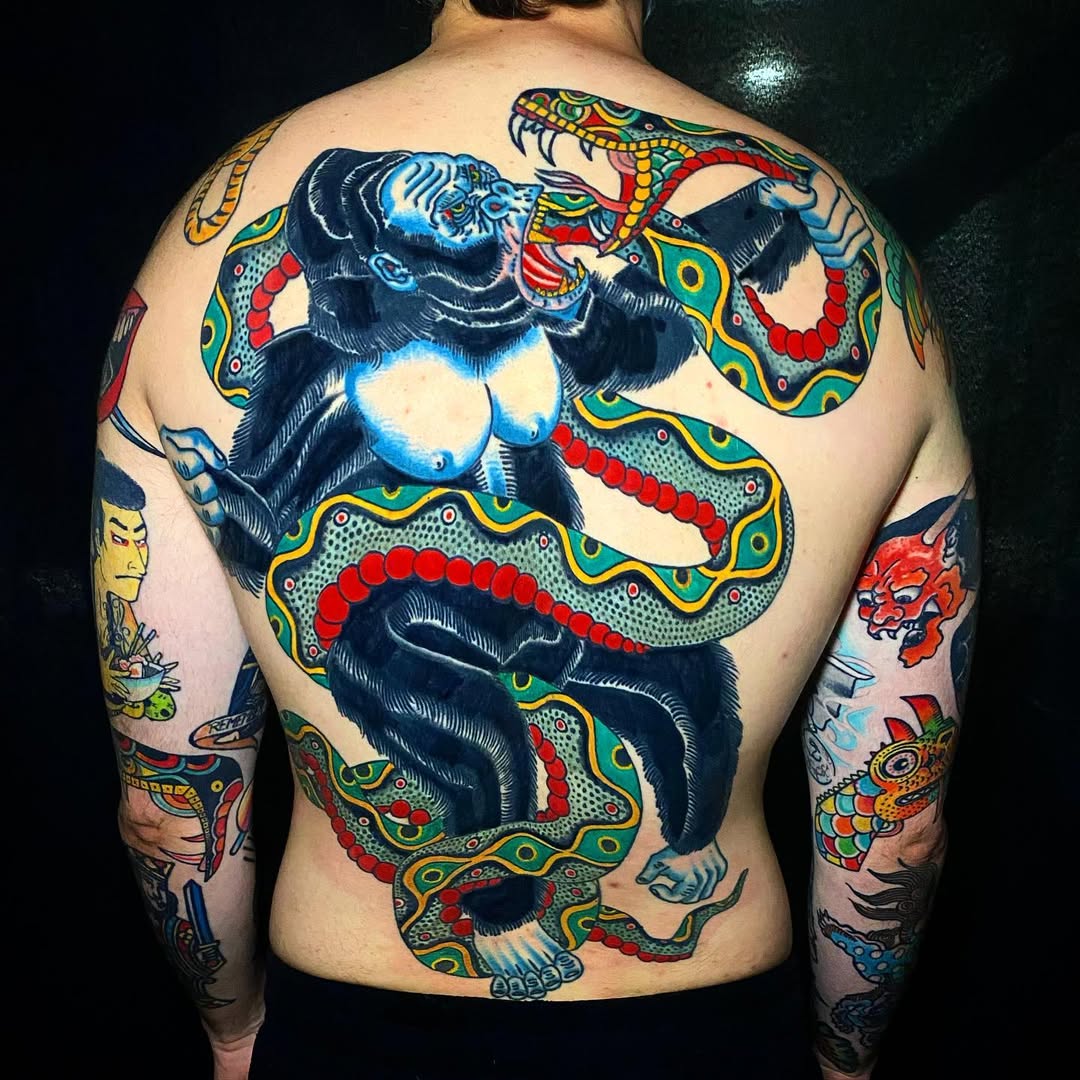 Bold back piece with snarling gorilla and vibrant serpent