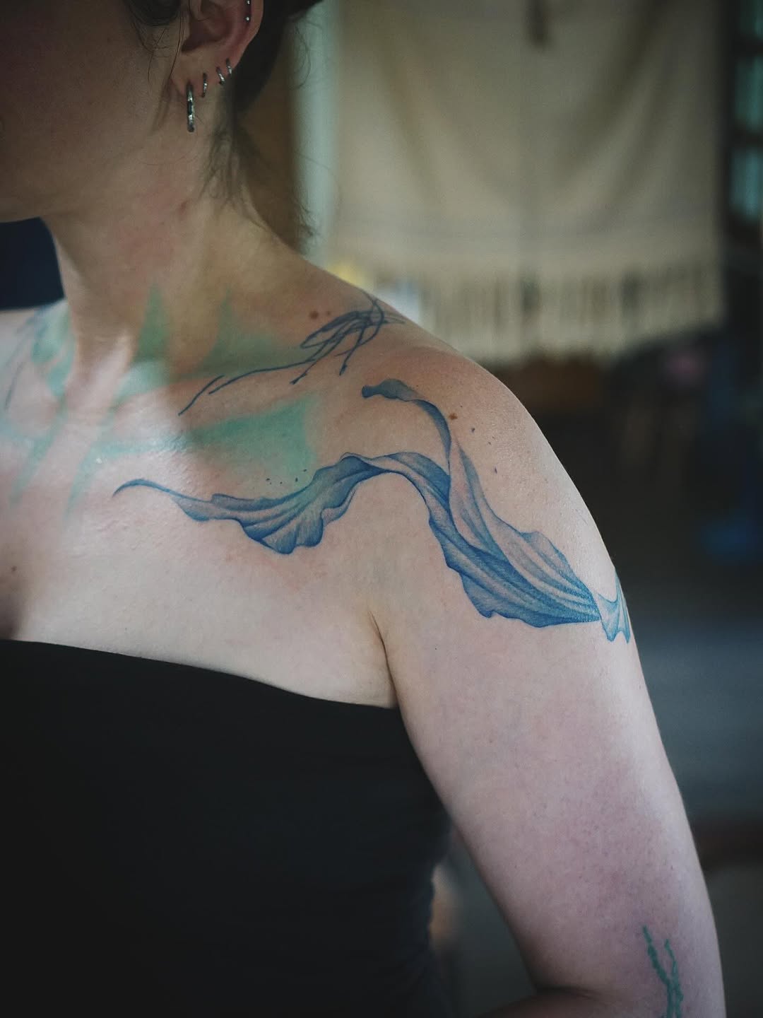 Fluid blue watercolor ribbon across shoulder