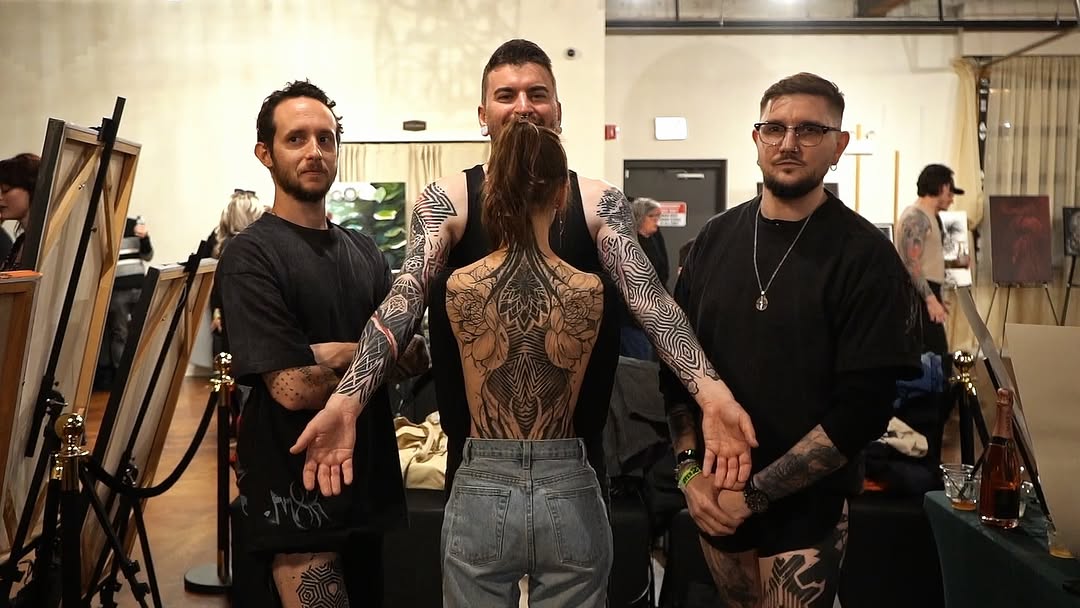 Intricate blackwork backpiece featuring symmetrical mandala motifs