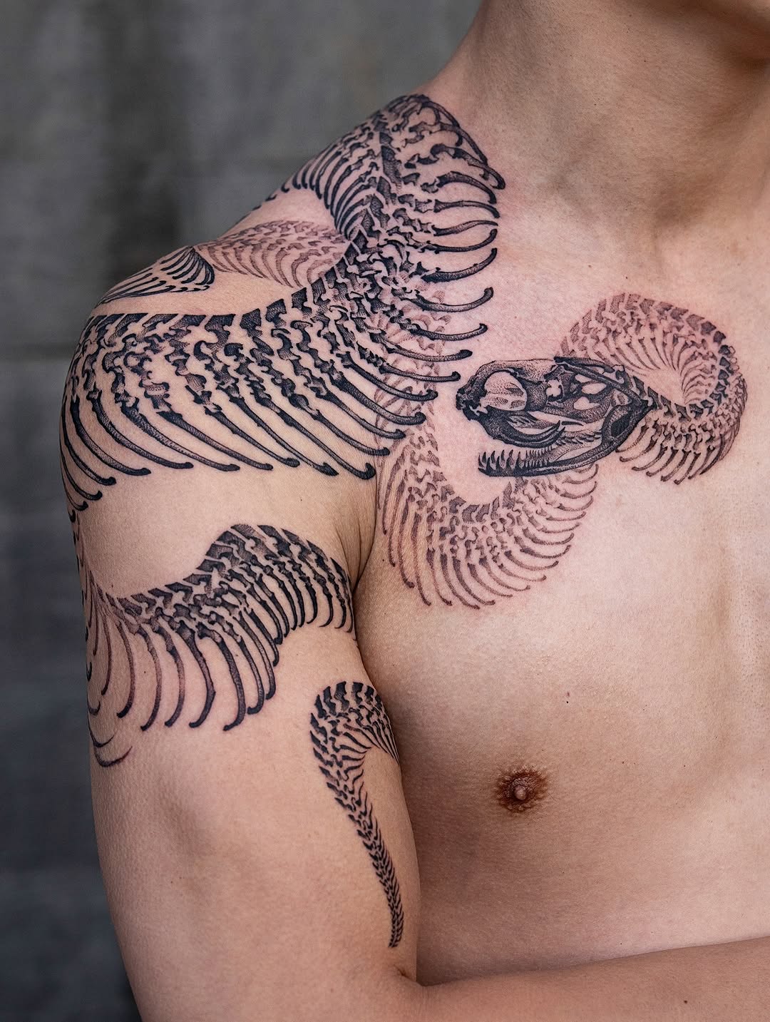 Intricate snake-skeleton wrap with bold linework