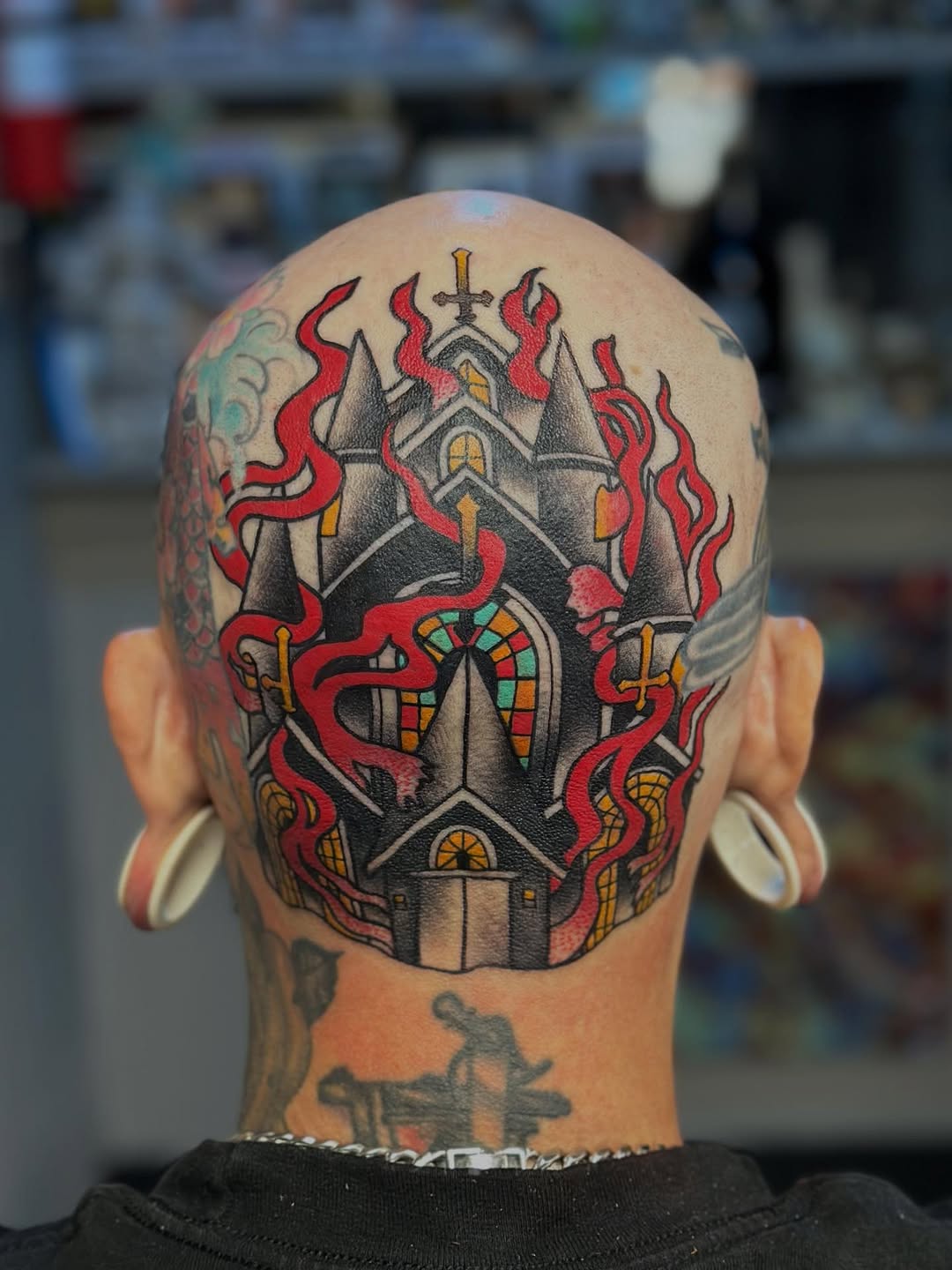 Bold neo-traditional castle on scalp with fiery tendrils