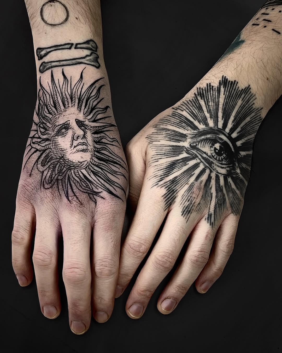 Dual sun-faced and eye motifs in bold linework