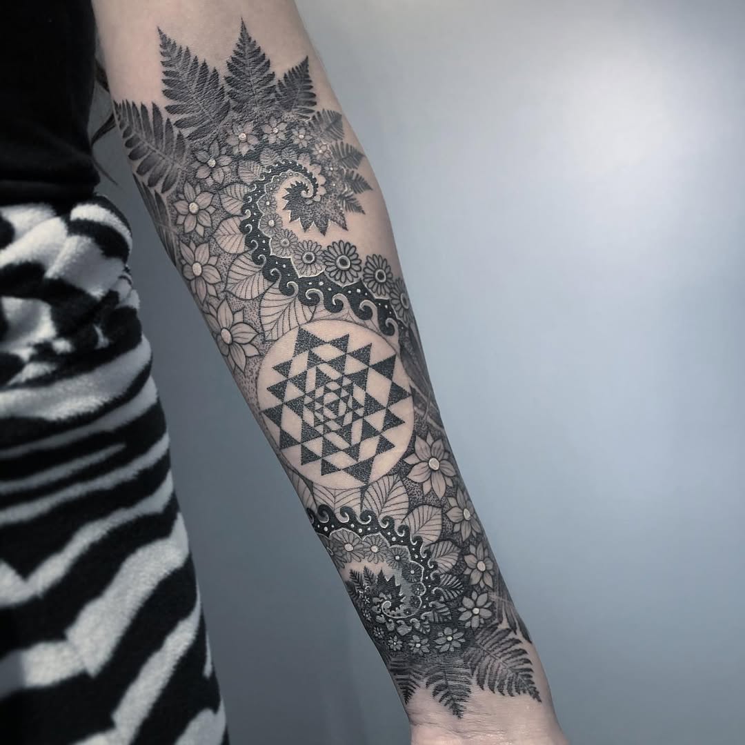 Intricate blackwork sleeve with Sri Yantra and florals