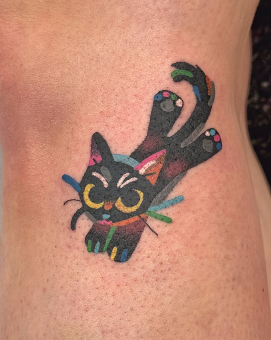 Playful black cat sploot with rainbow accents, cute whimsy