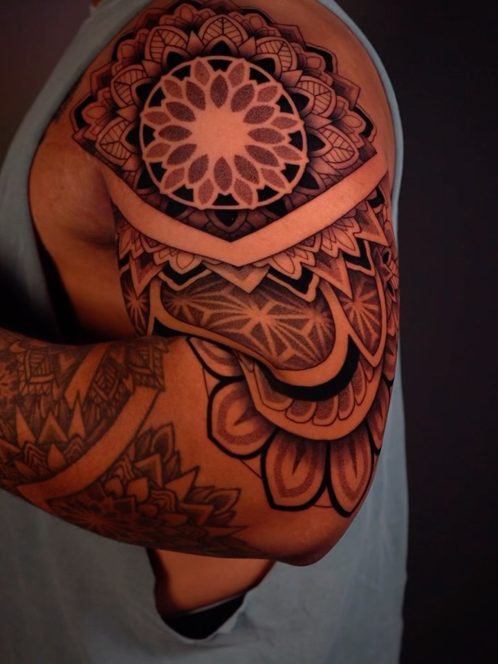 Bold ornamental mandala shoulder piece with geometric dotwork