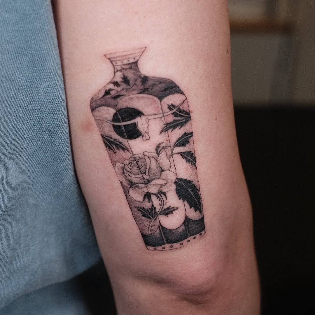 Elegant bottle-vase contains blooming rose, fine-line