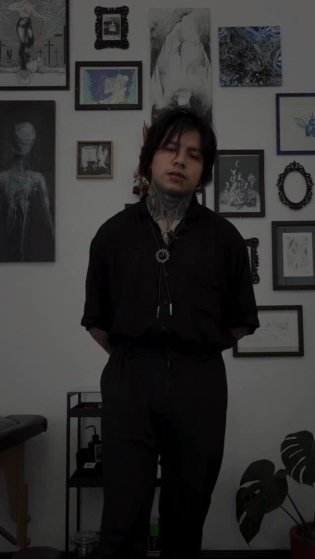 Bold blackwork neck piece with symmetrical ornamental shading.