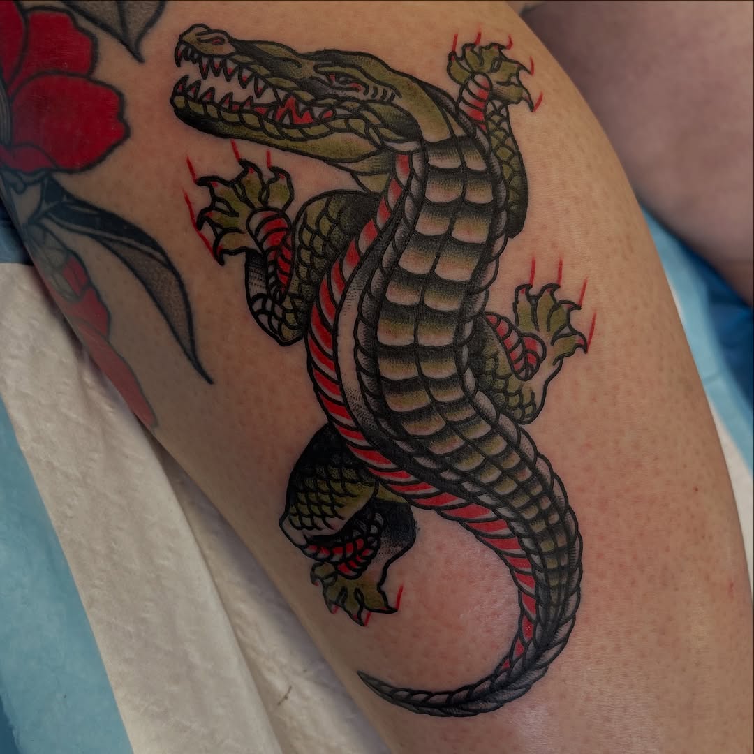 Bold neo-traditional crocodile bursts with color on thigh