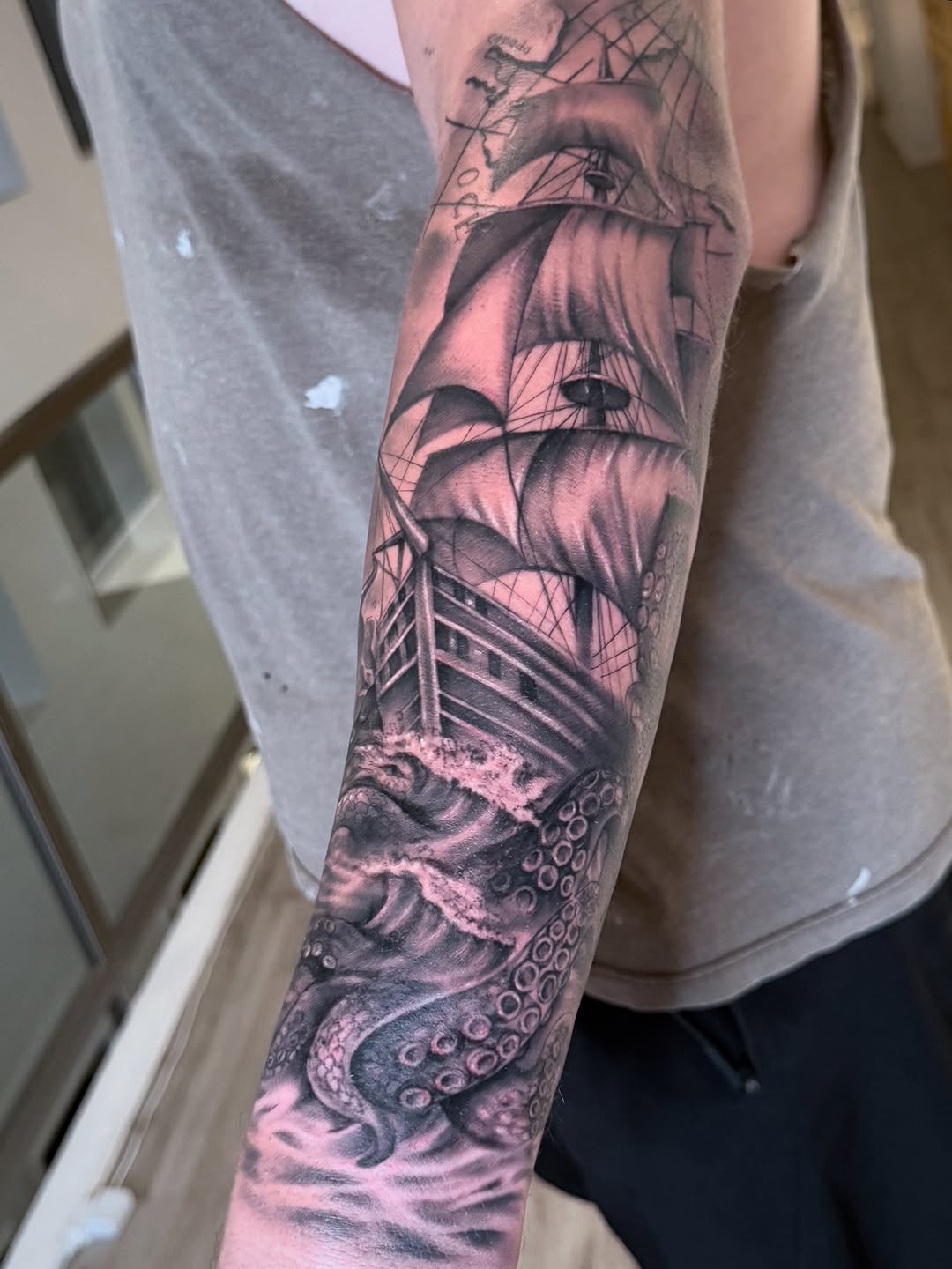 Dramatic black-and-gray nautical scene with ship and octopus