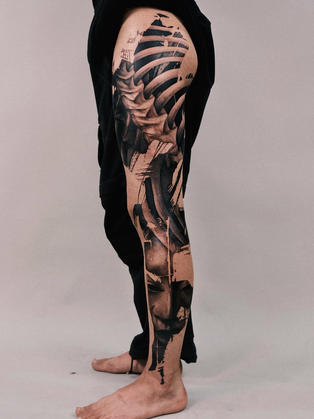 Monolithic black-and-gray leg sleeve with brushy abstraction