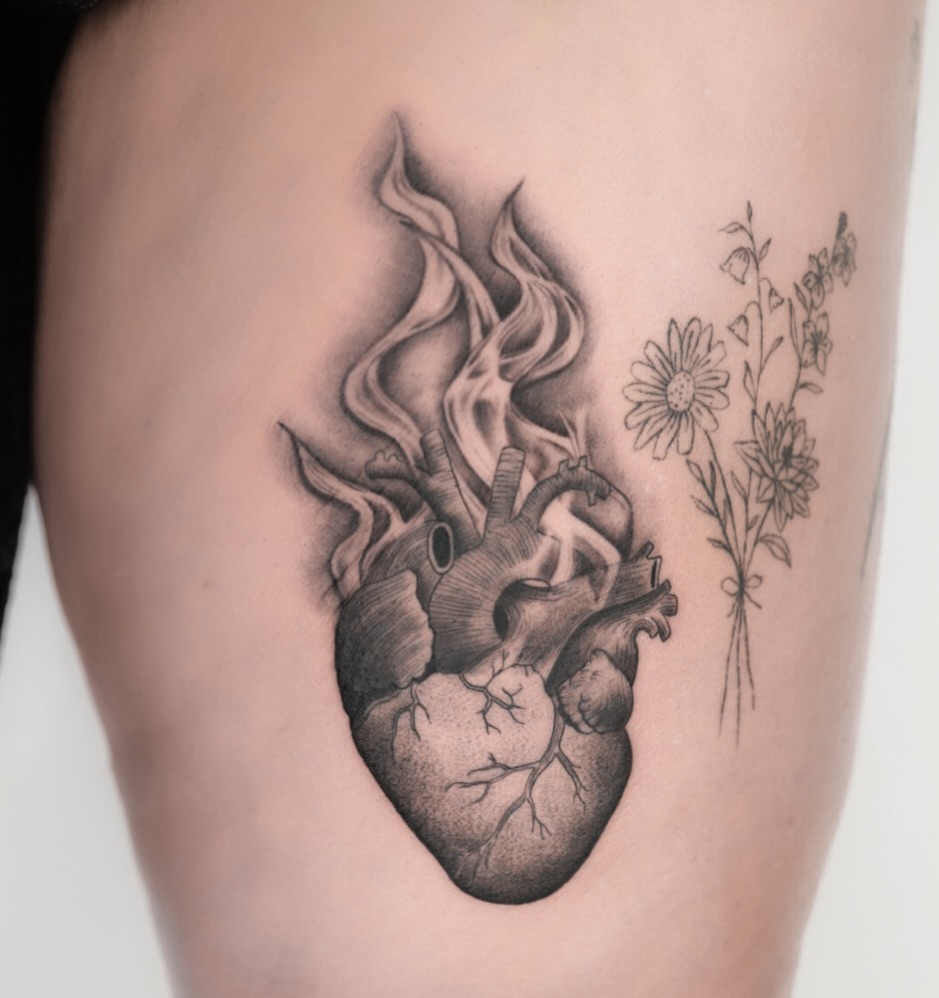 Anatomical heart on fire with flowing flames and florals
