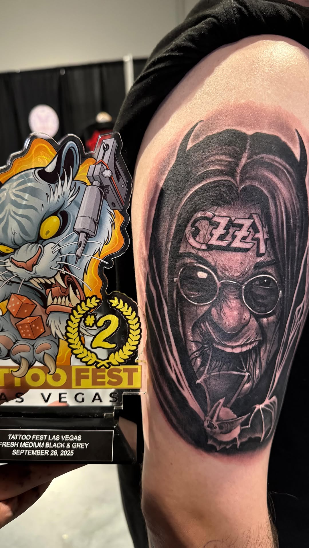 Photorealistic black-and-gray portrait of a rock icon.