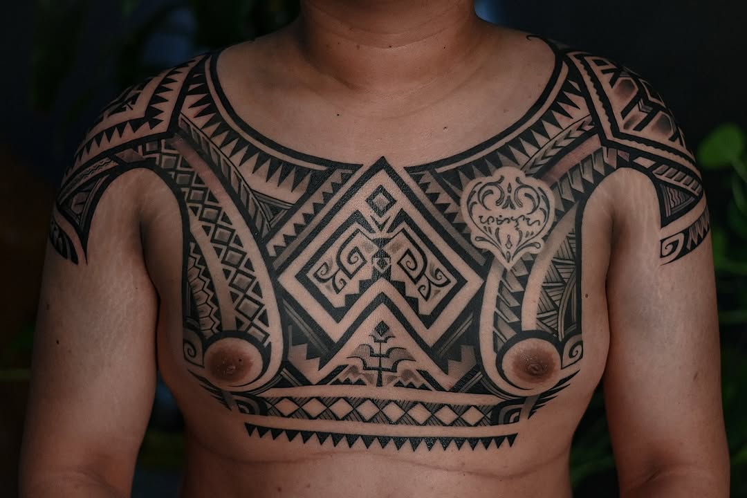 Monolithic blackwork chest armor with bold Filipino geometric patterns